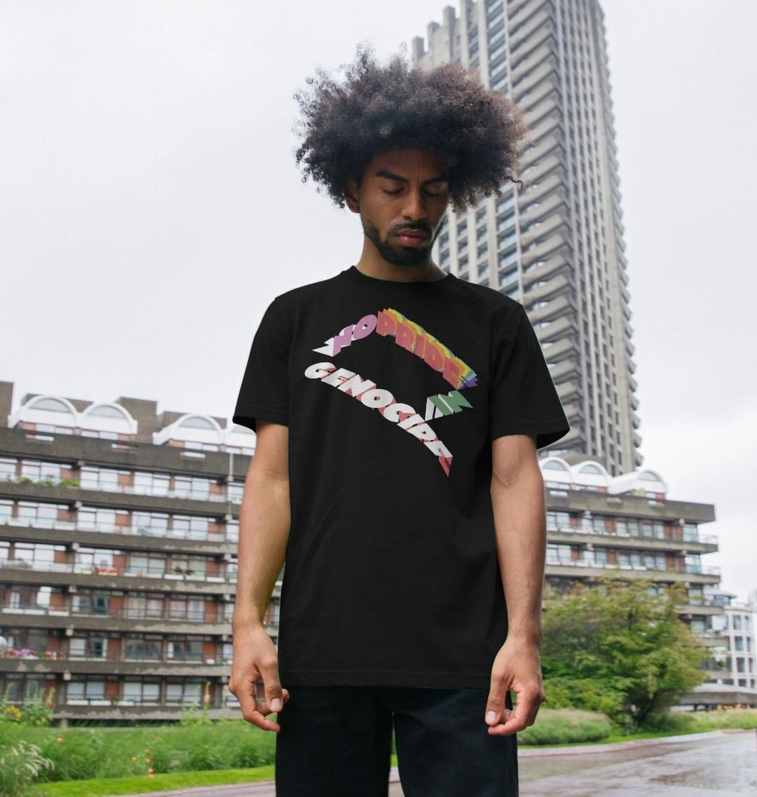 No pride in genocide black t-shirt. Man wearing the t-shirt in front of a building.