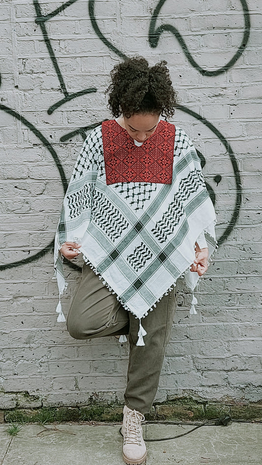 The traditional Keffiyeh redesigned as a comfortable and easy to wear poncho with traditional Palestinian Tatreez (embroidery), made in Hebron.