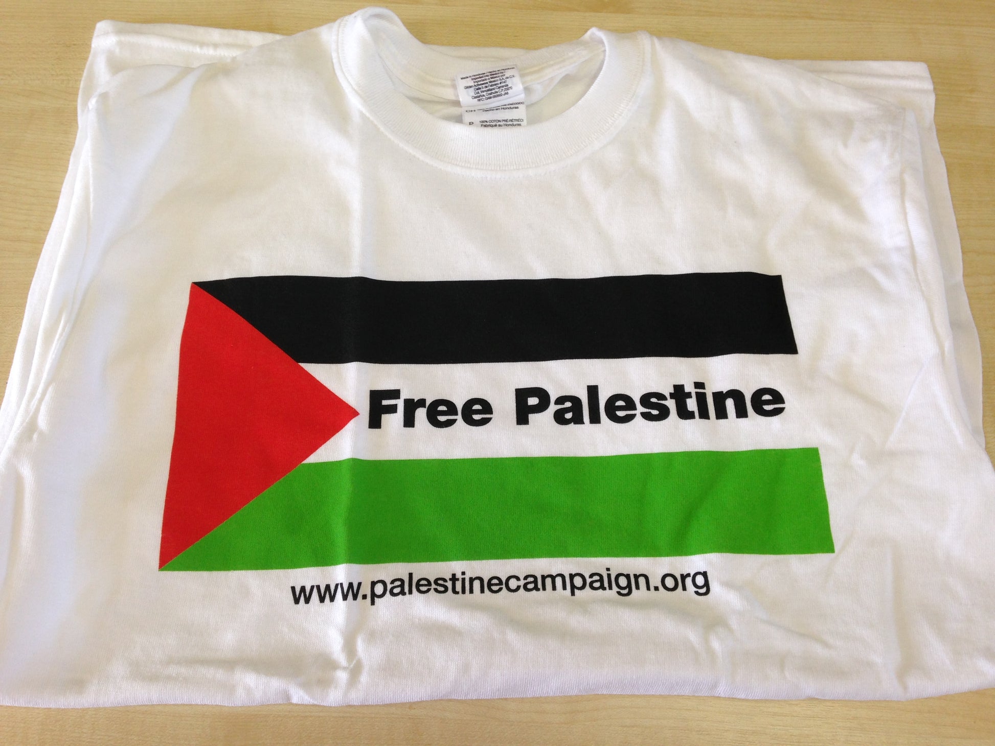 white t-shirt with Palestinian flag. Writing says Free Palestine